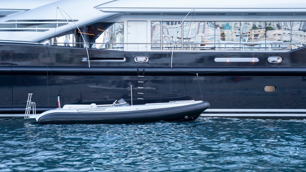 a superyacht tender pictured alongside a superyacht.